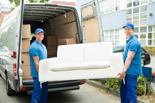 Movers packing delicate household items in a local home
