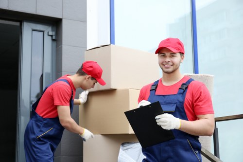 Commercial moving team transporting office items in Movers