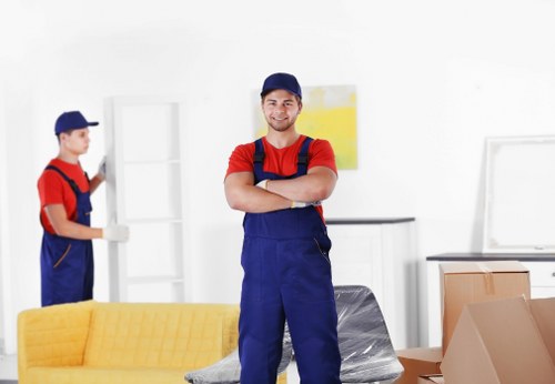 Professional movers handling furniture and packing for a home relocation