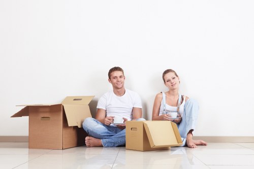 Removals crew handling residential furniture on a local street in Movers
