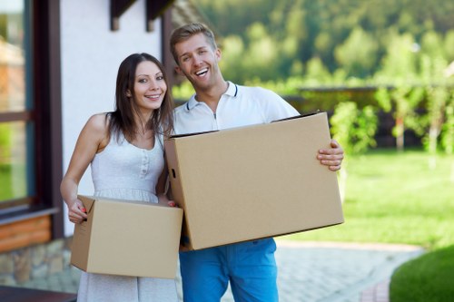 Professional movers handling furniture and boxes for a residential relocation