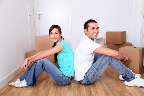 Local movers carrying office furniture from a commercial property